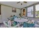 Enclosed sunroom featuring wicker furniture, ceiling fan, and natural light at 703 Chapel Hill W Dr, Indianapolis, IN 46214