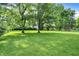 Expansive backyard boasts lush greenery, mature trees, and potential for outdoor activities and relaxation at 7600 S Oak Dr, Indianapolis, IN 46227