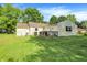 Charming backyard featuring a well-maintained lawn, a cozy patio, and a classic suburban home exterior at 7600 S Oak Dr, Indianapolis, IN 46227