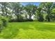 Lush backyard with mature trees and expansive green space offers a serene and private outdoor retreat at 7600 S Oak Dr, Indianapolis, IN 46227