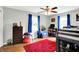 Stylish bedroom featuring hardwood floors, vibrant blue accents, and a cozy atmosphere, ideal for a room at 7600 S Oak Dr, Indianapolis, IN 46227