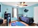 Charming bedroom with a ceiling fan, warm lighting, and a blue accent wall, perfect for a relaxing retreat at 7600 S Oak Dr, Indianapolis, IN 46227