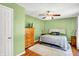 Comfortable bedroom with hardwood floors, a ceiling fan, and a queen-sized bed, creating a cozy retreat at 7600 S Oak Dr, Indianapolis, IN 46227