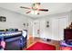 Bright bedroom with a ceiling fan, two closets, and a bunk bed, offering ample storage and a functional layout at 7600 S Oak Dr, Indianapolis, IN 46227