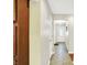 Bright hallway with tile flooring leads to a white front door with decorative oval glass insert at 7600 S Oak Dr, Indianapolis, IN 46227