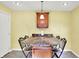 A breakfast bar area in kitchen features stone-style countertop, pendant lighting and decorative chairs at 7600 S Oak Dr, Indianapolis, IN 46227