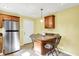 Eat-in kitchen featuring wooden cabinets, stainless steel appliances, tiled floor and a peninsula with seating at 7600 S Oak Dr, Indianapolis, IN 46227