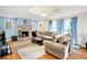 Inviting living room with a stone fireplace, hardwood floors, and comfortable seating at 7600 S Oak Dr, Indianapolis, IN 46227
