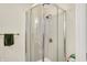 Bathroom featuring glass-enclosed shower with black and white patterned tiles and chrome fixtures at 7600 S Oak Dr, Indianapolis, IN 46227