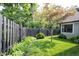 Well maintained backyard features lush green grass and a black wooden fence, ensuring privacy at 7686 Micawber Ct, Indianapolis, IN 46256