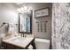 Neutral bathroom with a decorative mirror, toilet, and shower curtain at 7686 Micawber Ct, Indianapolis, IN 46256