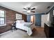Bedroom with a ceiling fan, wood accent wall, and blue-painted walls at 7686 Micawber Ct, Indianapolis, IN 46256