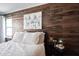 Bedroom features a cozy bed with white linens and a decorative wood accent wall at 7686 Micawber Ct, Indianapolis, IN 46256