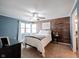 Bedroom with a blue accent wall and a decorative wood panel wall feature at 7686 Micawber Ct, Indianapolis, IN 46256