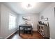 Bright dining area with a modern table and chairs, complemented by stylish decor and natural light from the window at 7686 Micawber Ct, Indianapolis, IN 46256