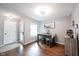 Cozy dining room with wood floors, a modern table, and a window for natural light at 7686 Micawber Ct, Indianapolis, IN 46256