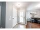 Bright entryway with a glass-paneled front door and a view into the adjacent dining area at 7686 Micawber Ct, Indianapolis, IN 46256