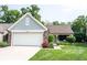 Charming single Gathering home featuring a two-car garage, a well-manicured lawn, and lovely red roses at 7686 Micawber Ct, Indianapolis, IN 46256