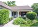 Inviting front porch with decorative plants and a seating area, ideal for outdoor living at 7686 Micawber Ct, Indianapolis, IN 46256