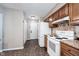 This kitchen is equipped with white appliances and offers access to the backyard at 7686 Micawber Ct, Indianapolis, IN 46256