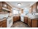 A well-lit kitchen boasts wooden cabinets, granite counters and a breakfast bar at 7686 Micawber Ct, Indianapolis, IN 46256