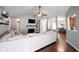 Open-concept living room featuring a fireplace, TV, and a neutral-toned sectional sofa, seamlessly connecting to the dining area at 7686 Micawber Ct, Indianapolis, IN 46256