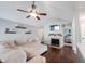 Comfortable living room featuring a ceiling fan, fireplace, and neutral-toned sectional sofa, creating a relaxing atmosphere at 7686 Micawber Ct, Indianapolis, IN 46256