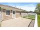 Backyard view of a brick home with a concrete patio and a white picket fence at 7687 Sea Crest N Way, Noblesville, IN 46062