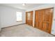 This bedroom offers natural light, neutral carpet, and closet space at 7687 Sea Crest N Way, Noblesville, IN 46062