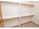 Empty closet with built-in shelves and wood rods provides ample storage space at 7687 Sea Crest N Way, Noblesville, IN 46062