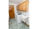 Laundry room with washer, dryer, utility sink, and storage cabinets at 7687 Sea Crest N Way, Noblesville, IN 46062