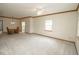 Open-concept living space featuring neutral carpet and ceiling fan at 7687 Sea Crest N Way, Noblesville, IN 46062