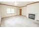Spacious living room with neutral carpet, fireplace and ceiling fan at 7687 Sea Crest N Way, Noblesville, IN 46062