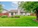Well-maintained backyard with lush green grass, mature tree and nice landscaping at 7918 Bitternut Dr, Indianapolis, IN 46236