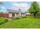 Well-maintained backyard with lush green grass, mature tree and nice landscaping at 7918 Bitternut Dr, Indianapolis, IN 46236