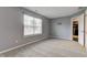 This bedroom features neutral walls, plush carpet, and a window to let in natural light at 7918 Bitternut Dr, Indianapolis, IN 46236