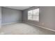 Neutral bedroom with natural light, carpet and large window at 7918 Bitternut Dr, Indianapolis, IN 46236