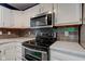 Updated kitchen features stainless steel appliances, modern backsplash, and bright countertops at 7918 Bitternut Dr, Indianapolis, IN 46236