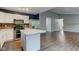 Modern kitchen featuring stainless steel appliances, eat-in island, and convenient breakfast bar at 7918 Bitternut Dr, Indianapolis, IN 46236