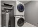 Laundry room with stacked Samsung washer/dryer and shelving at 7918 Bitternut Dr, Indianapolis, IN 46236
