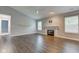 Bright living room featuring a cozy fireplace, hardwood flooring, and modern finishes at 7918 Bitternut Dr, Indianapolis, IN 46236