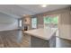 Open living area with a cozy fireplace, sliding doors to backyard, and eat-in kitchen island at 7918 Bitternut Dr, Indianapolis, IN 46236