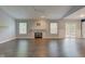 Spacious living room with stylish hardwood floors, a modern fireplace, and sliding doors to the outdoor space at 7918 Bitternut Dr, Indianapolis, IN 46236