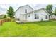 A home's backyard with a wooden deck, lush lawn, and wood fence under a bright sky at 852 Yellowwood Dr, Greenwood, IN 46143