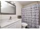 Bathroom with a white vanity, decorative mirror, and bathtub with a gray ruffled curtain at 852 Yellowwood Dr, Greenwood, IN 46143