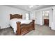 Spacious bedroom with a large carved wood bed frame and an en-suite bathroom at 852 Yellowwood Dr, Greenwood, IN 46143