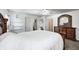 Bedroom featuring a large carved wood bed frame, dresser, and access to en-suite bath and closets at 852 Yellowwood Dr, Greenwood, IN 46143