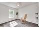 Well-lit bedroom with a light rocking chair, a window, and neutral decor at 852 Yellowwood Dr, Greenwood, IN 46143