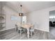 Bright dining room with a stylish chandelier and a view to the living room at 852 Yellowwood Dr, Greenwood, IN 46143