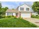 Charming two-story home with a well-manicured lawn and a two-car garage at 852 Yellowwood Dr, Greenwood, IN 46143